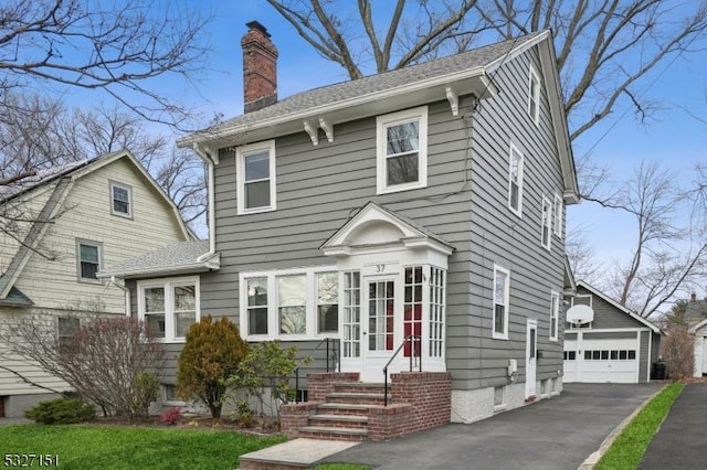 view of front of home featuring a garage and an outdoor structure