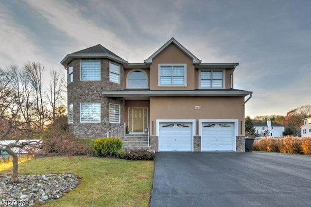 view of front of home featuring a lawn and a garage