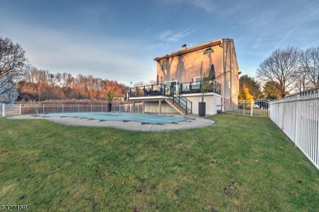 exterior space featuring a yard and a covered pool