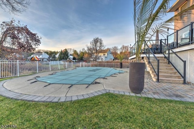 view of swimming pool with a yard and a patio area