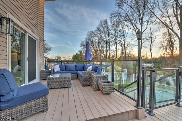 deck at dusk with an outdoor hangout area