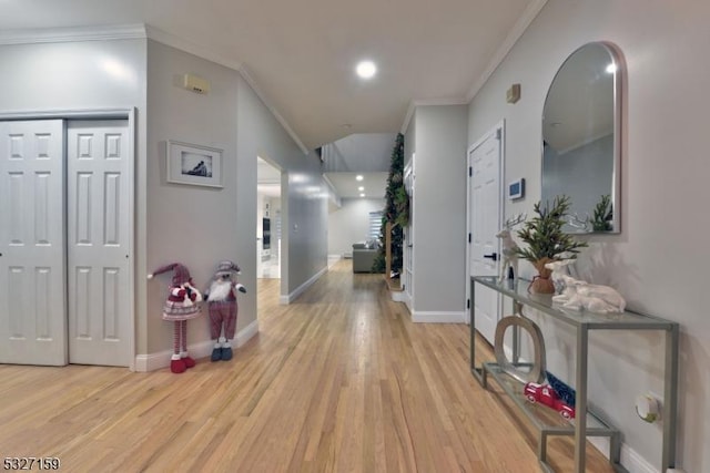 corridor with crown molding and light hardwood / wood-style flooring