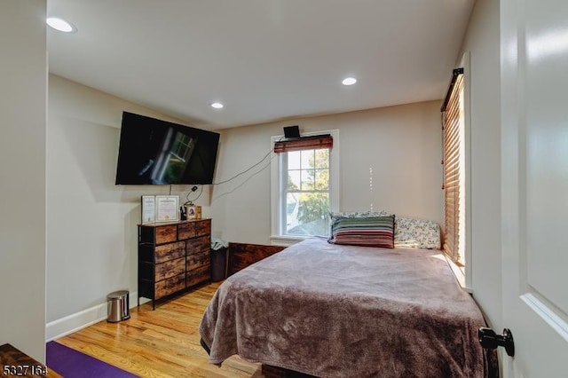 bedroom with hardwood / wood-style flooring