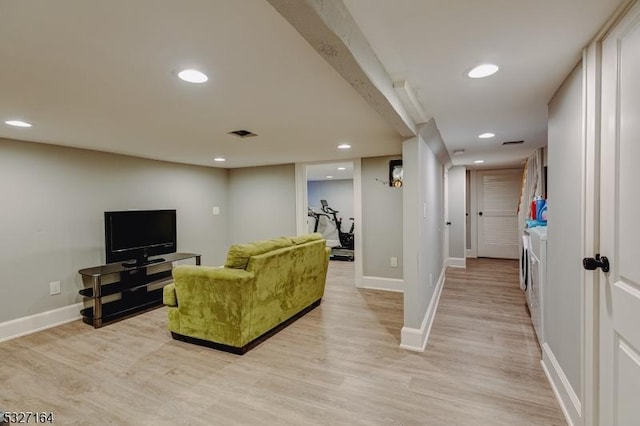 living room featuring light hardwood / wood-style flooring and washing machine and dryer