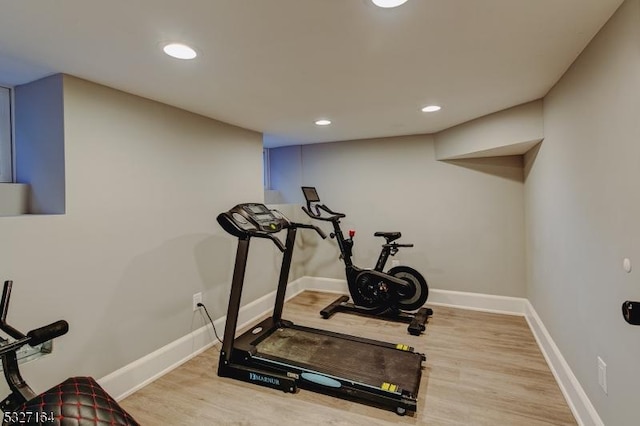 workout room featuring light hardwood / wood-style flooring