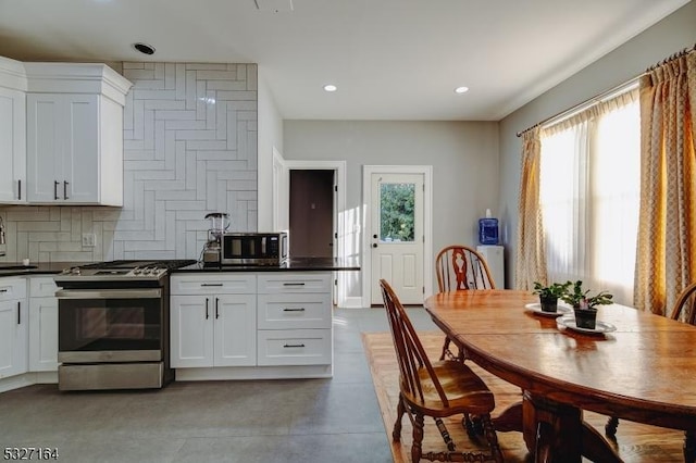 kitchen with white cabinetry, backsplash, and stainless steel appliances