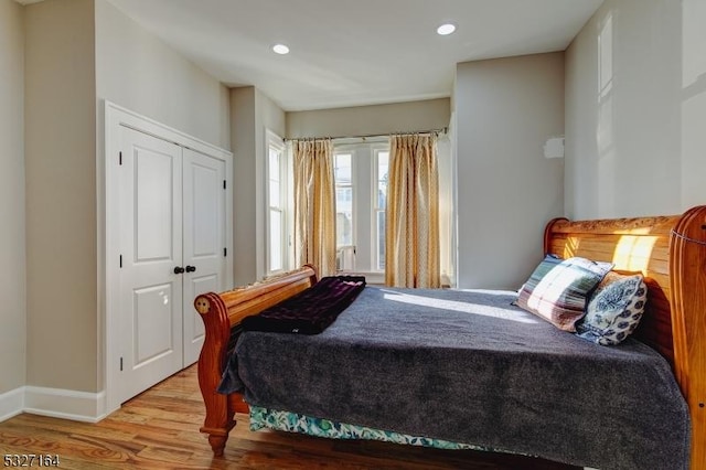 bedroom featuring a closet and light hardwood / wood-style flooring