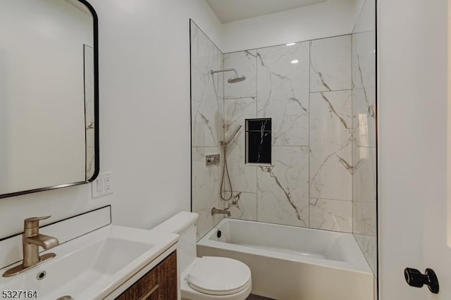 full bathroom featuring tiled shower / bath combo, vanity, and toilet