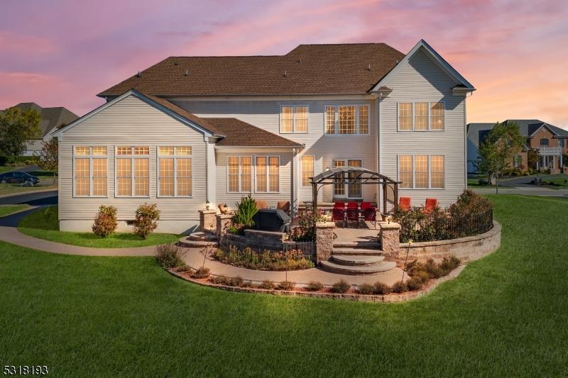 4 Ten Eyck Rd S, Branchburg Twp, NJ 08876 - back of house at dusk featuring a lawn, a patio, and a pergola
