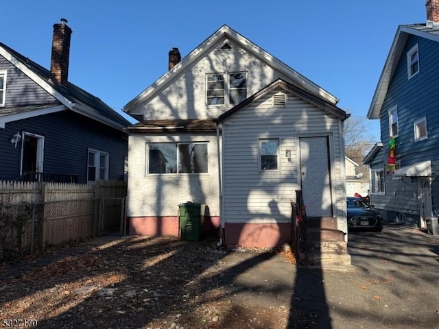 back of property with fence