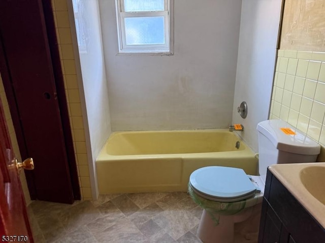 full bath with toilet, tile walls, and vanity