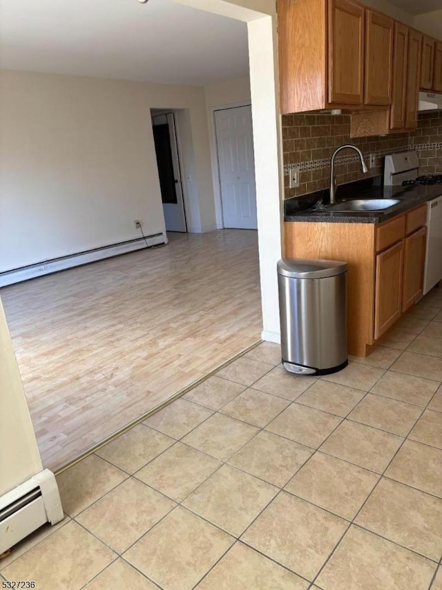 kitchen with light wood-type flooring, white range with gas stovetop, sink, and baseboard heating