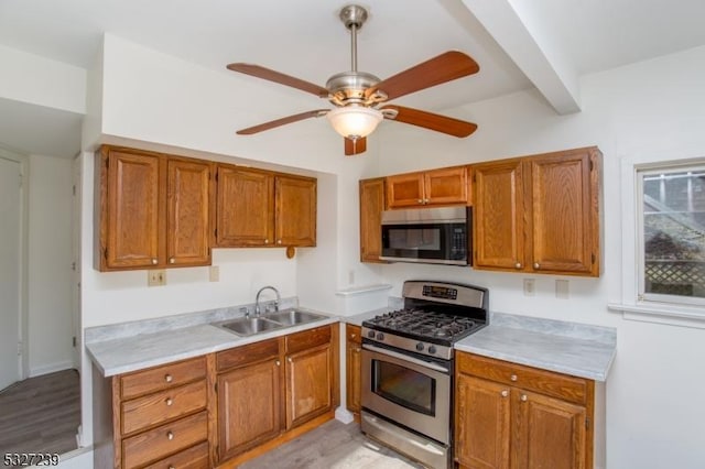 kitchen featuring ceiling fan, light wood-type flooring, sink, and appliances with stainless steel finishes