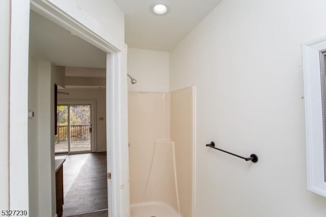 bathroom with wood-type flooring and walk in shower