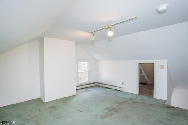 additional living space featuring carpet flooring, a baseboard radiator, and vaulted ceiling