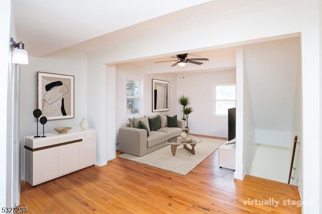 living room featuring plenty of natural light, ceiling fan, and light hardwood / wood-style flooring