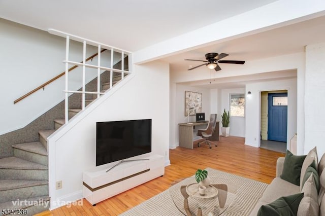 living room featuring ceiling fan and hardwood / wood-style floors