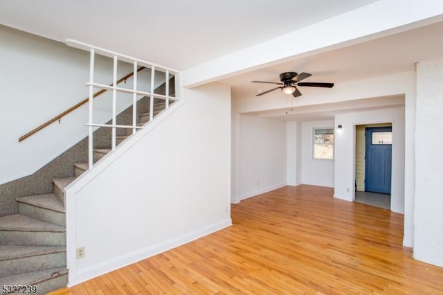 unfurnished living room featuring ceiling fan and wood-type flooring