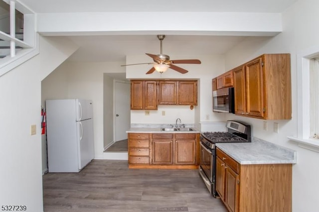 kitchen with ceiling fan, dark hardwood / wood-style flooring, sink, and appliances with stainless steel finishes