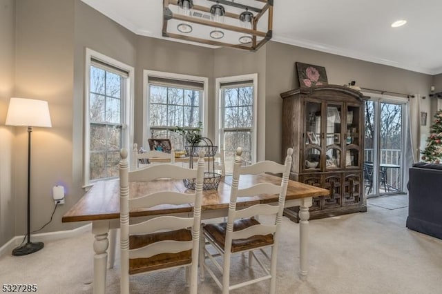 dining space with carpet floors and ornamental molding