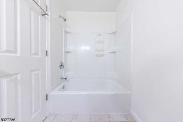 bathroom featuring tile patterned flooring and  shower combination