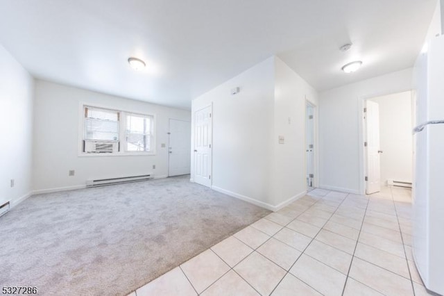 carpeted spare room with a baseboard radiator