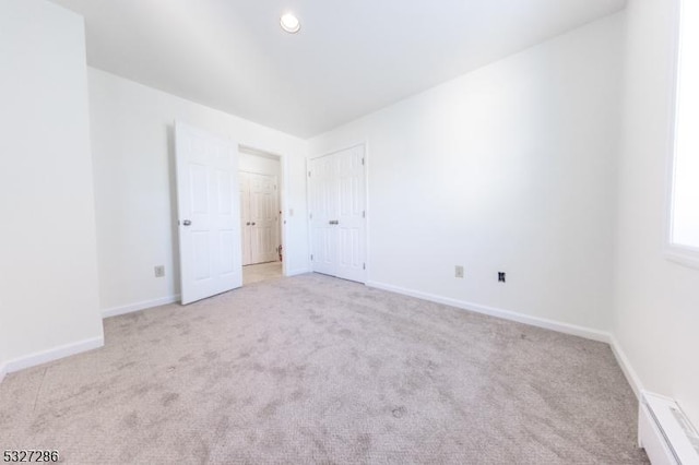 unfurnished room featuring light carpet