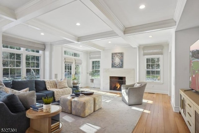 living room featuring a high end fireplace, beam ceiling, crown molding, and coffered ceiling