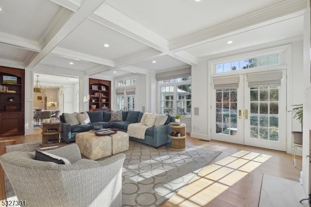 living room featuring coffered ceiling, beam ceiling, and french doors