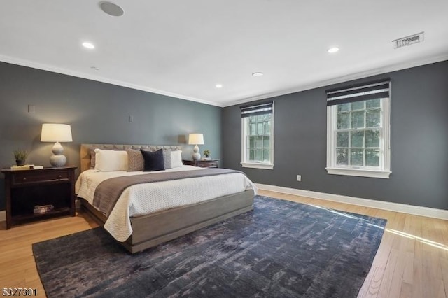 bedroom with wood-type flooring and crown molding