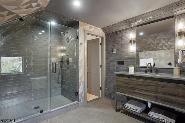 bathroom with tile patterned flooring, vanity, and a shower with door