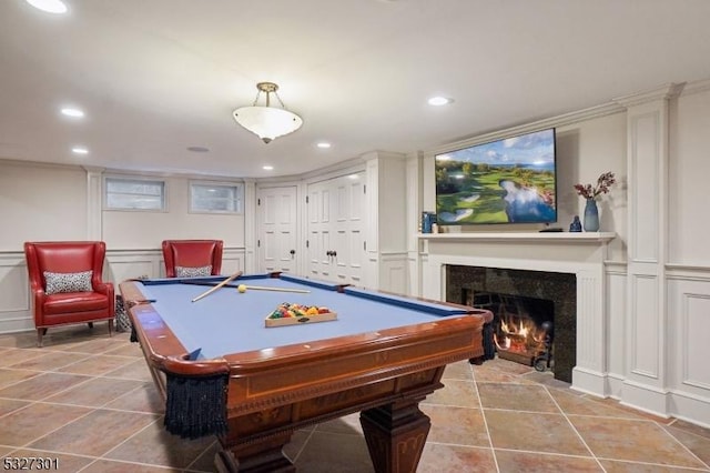 playroom with a tiled fireplace and billiards