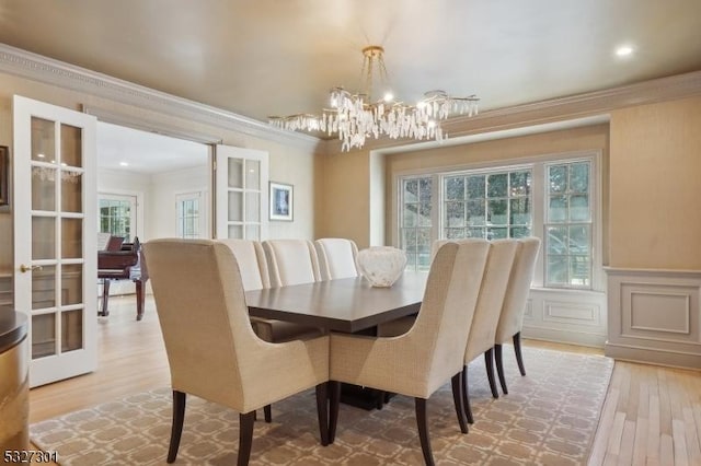 dining area with french doors, a healthy amount of sunlight, and ornamental molding