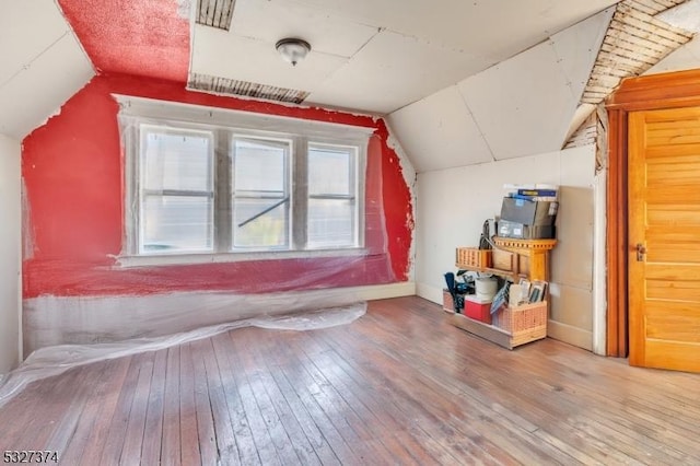 bonus room featuring hardwood / wood-style flooring and vaulted ceiling