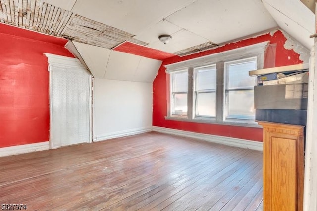 bonus room featuring hardwood / wood-style flooring and lofted ceiling