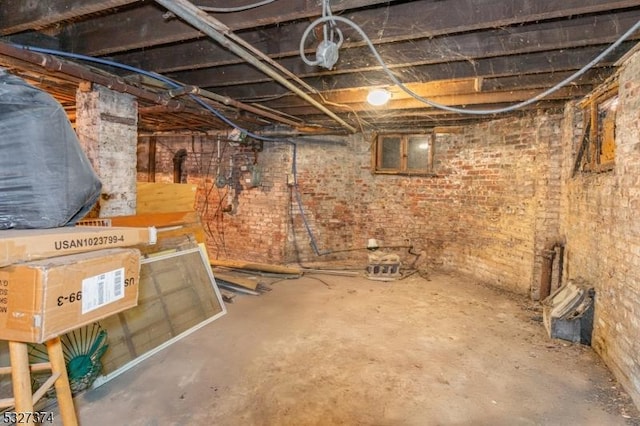 basement featuring brick wall