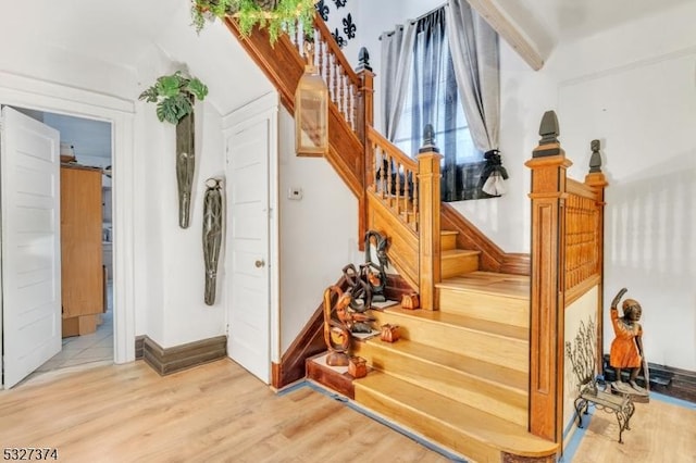 staircase featuring wood-type flooring