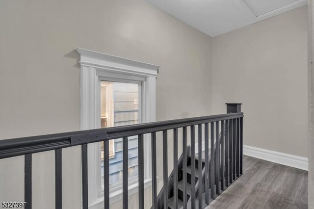 corridor with hardwood / wood-style flooring