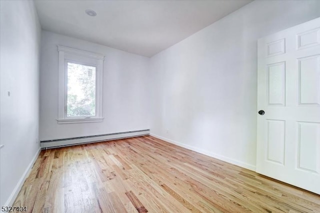 spare room featuring light hardwood / wood-style floors and baseboard heating
