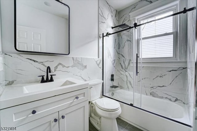 full bathroom featuring tasteful backsplash, vanity, shower / bath combination with glass door, tile walls, and toilet