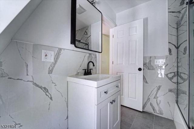 bathroom featuring tile patterned flooring, vanity, and walk in shower
