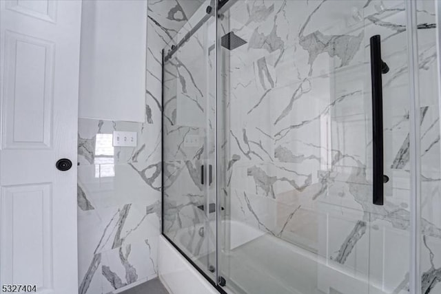 bathroom featuring shower / bath combination with glass door