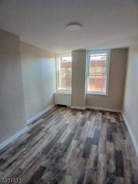 spare room featuring dark hardwood / wood-style flooring