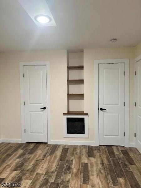 unfurnished living room featuring dark wood-type flooring