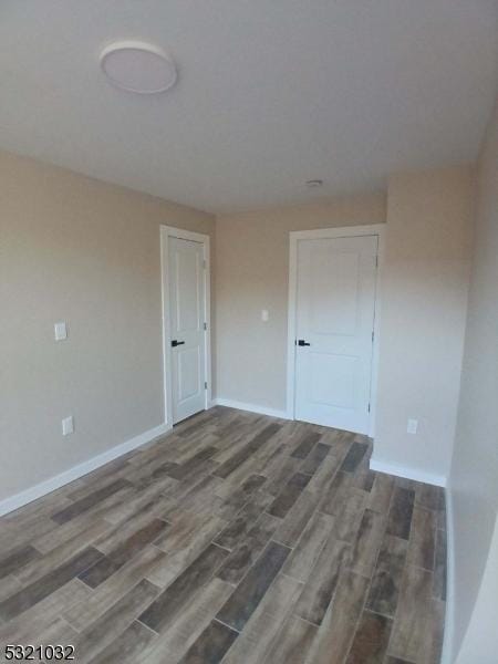 empty room featuring dark wood-type flooring