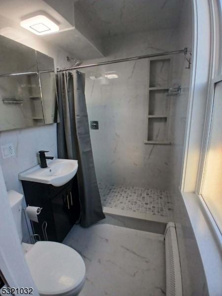 bathroom featuring toilet, vanity, and a shower with shower curtain