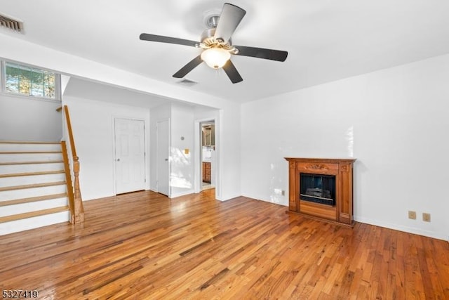 unfurnished living room with light hardwood / wood-style flooring and ceiling fan