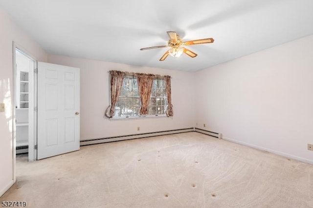 carpeted spare room with baseboard heating and ceiling fan