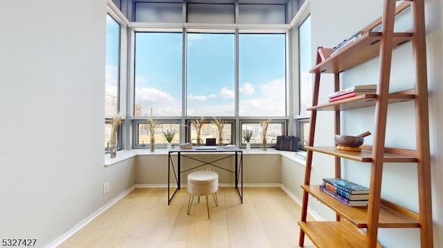 home office with light hardwood / wood-style floors