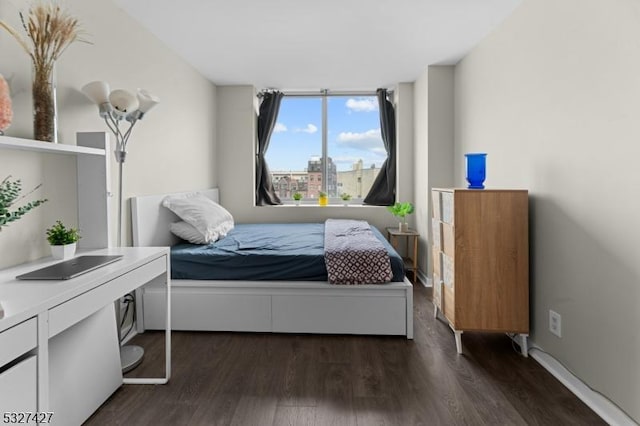 bedroom with dark hardwood / wood-style floors